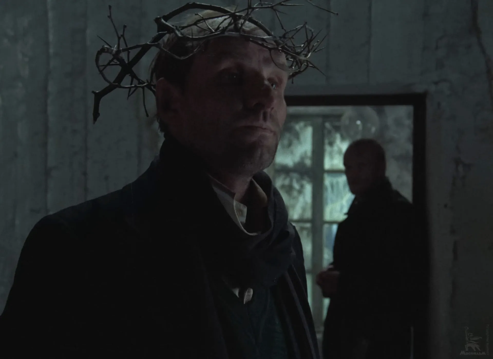 The Writer wearing his wreath of twigs like a crown of thorns, the Stalker behind him by the window.