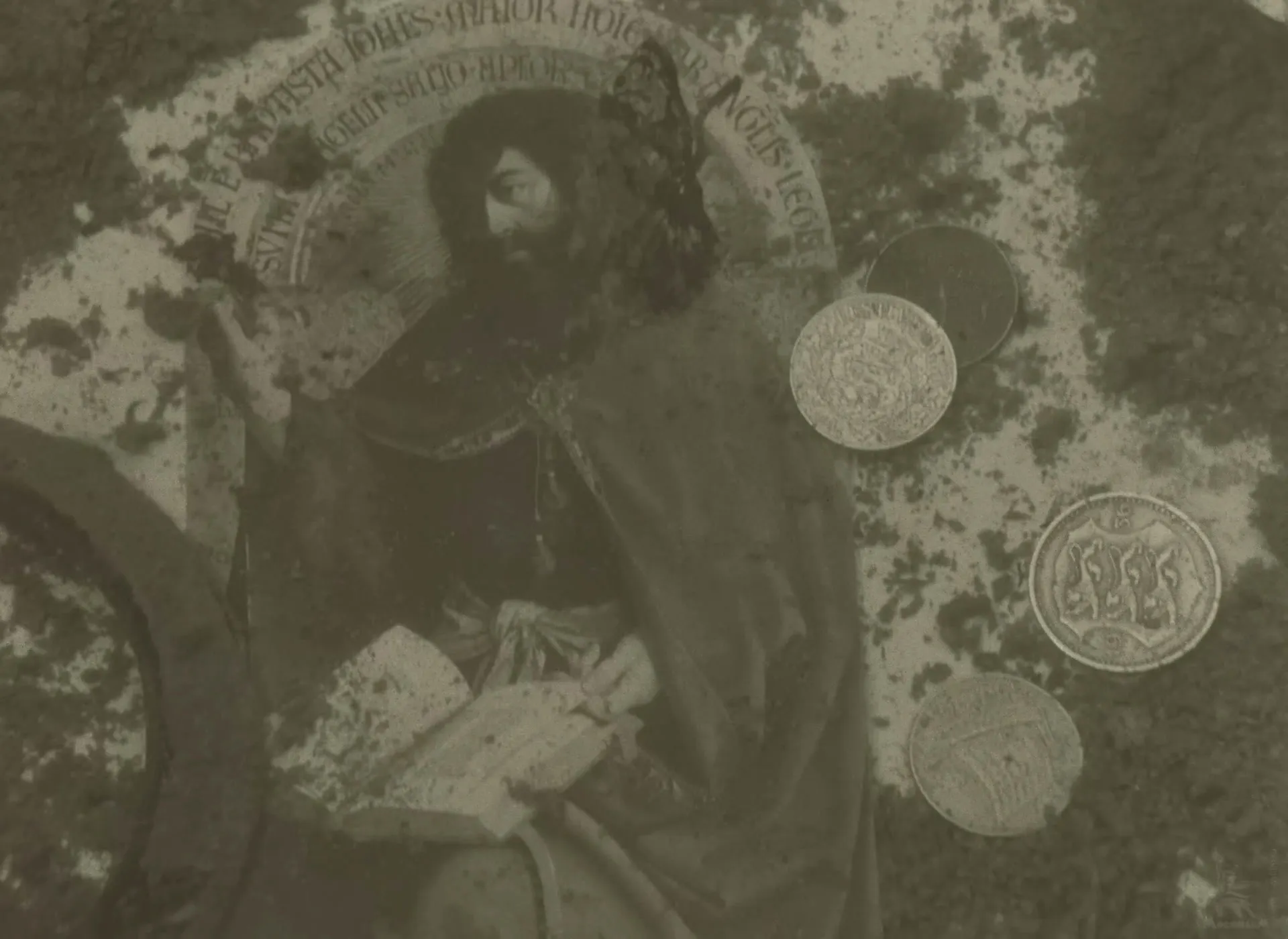 A reproduction of Van Eyck’s John the Baptist, from the Ghent Altarpiece, under the water with coins lying on it.